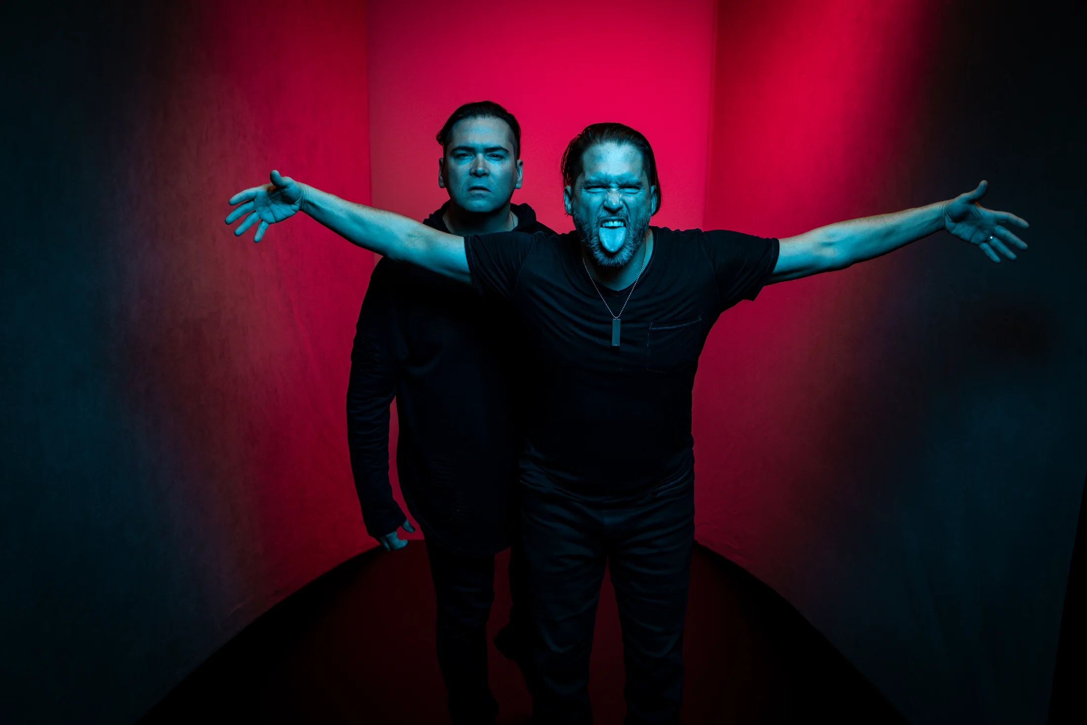 Aranda with arms outstretched in red and blue light
