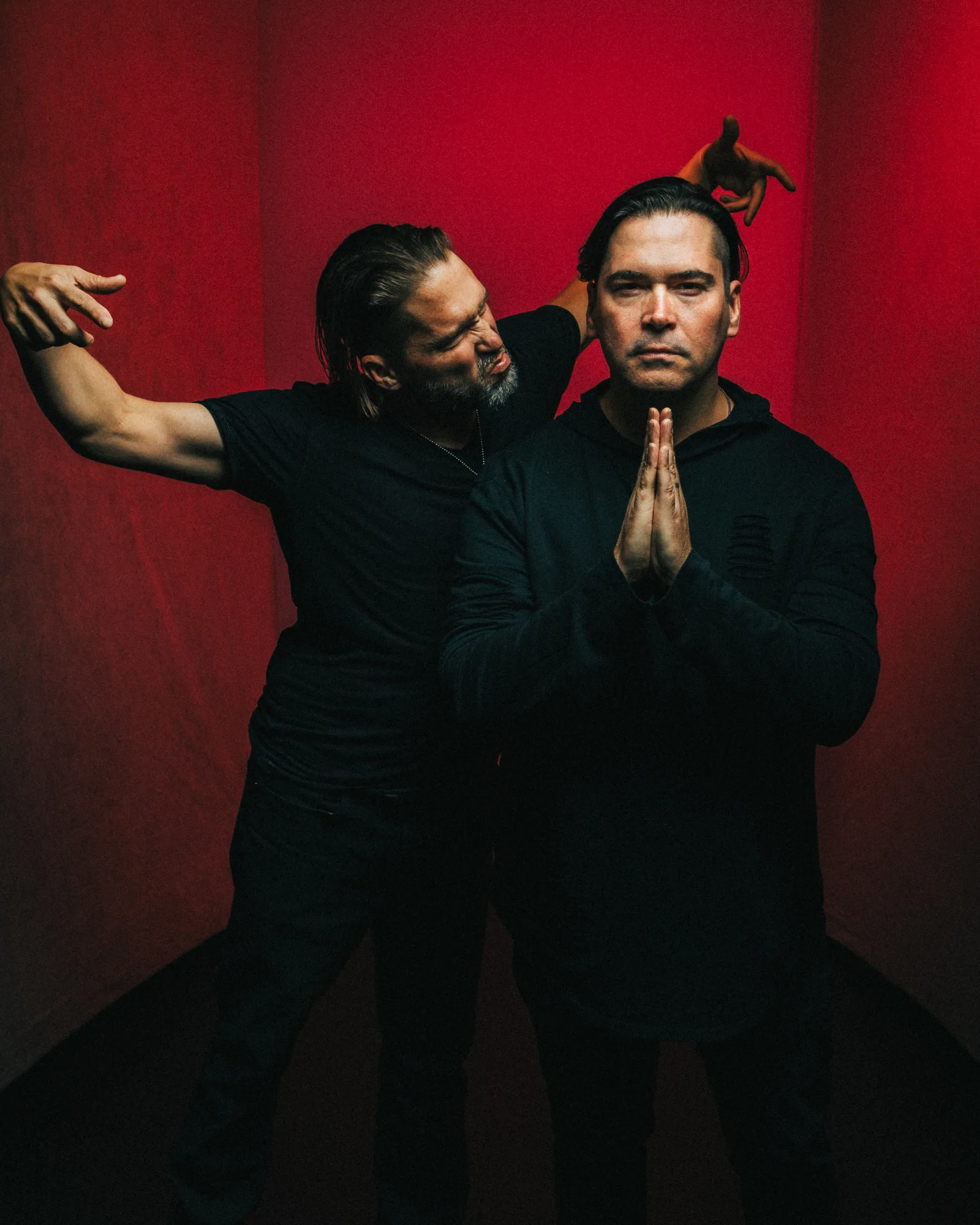 Dameon and Gabe Aranda photographed against a red backdrop