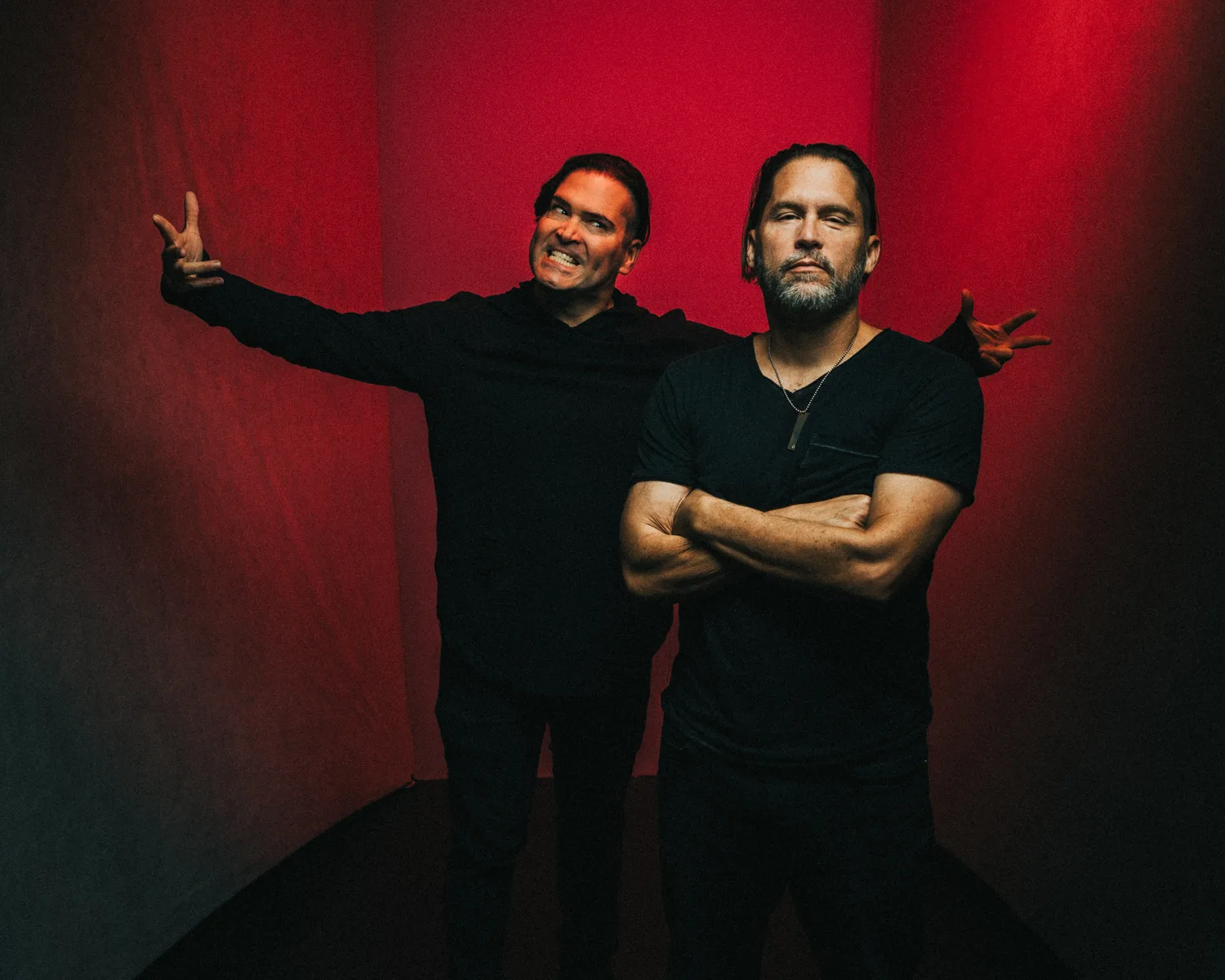 Aranda in red light, arms raised
